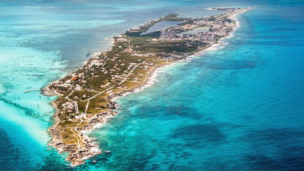 Sail on a luxurious catamaran to Isla Mujeres with turquoise waters all around.